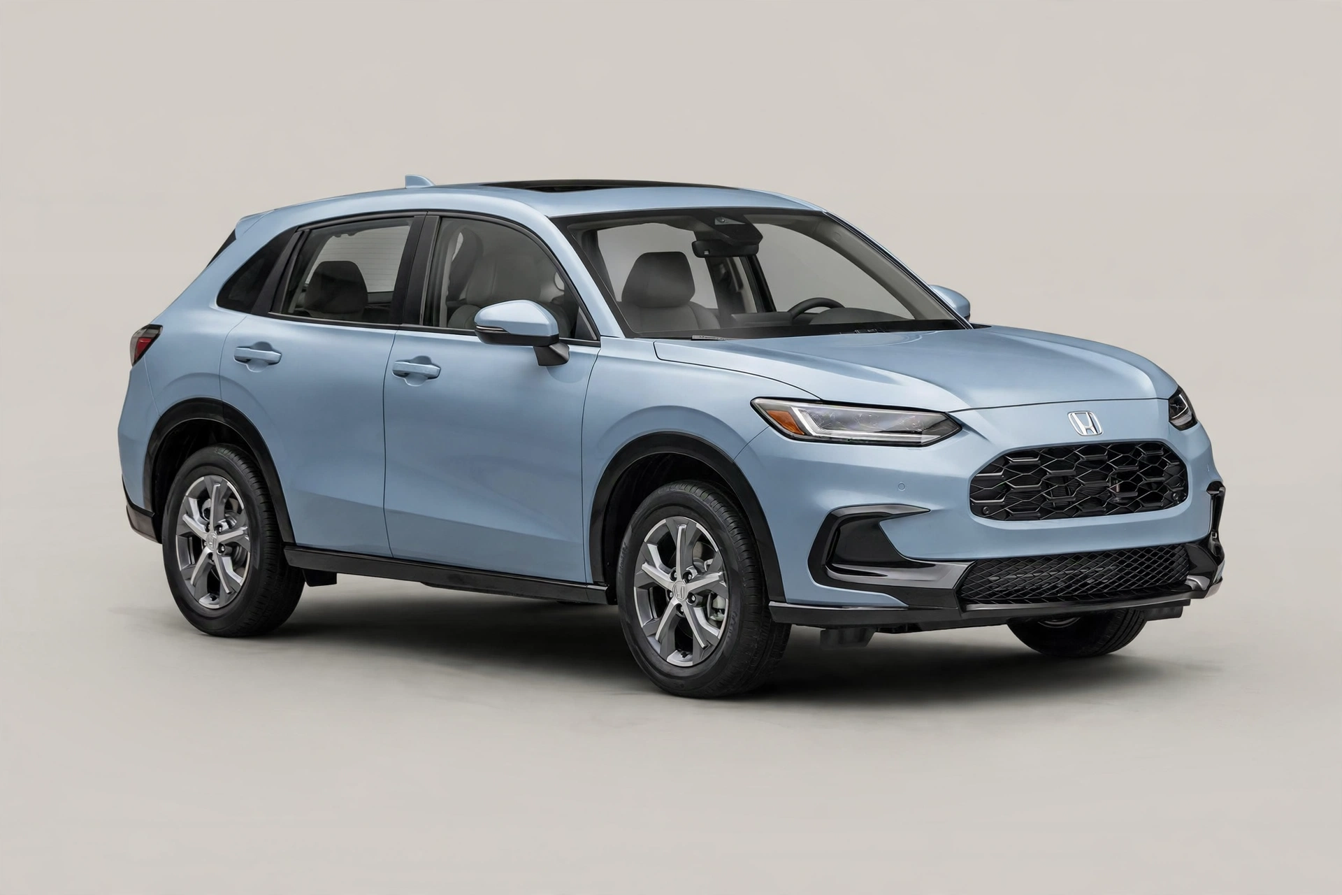 Light blue Honda HR-V subcompact SUV in a studio, front three-quarter view