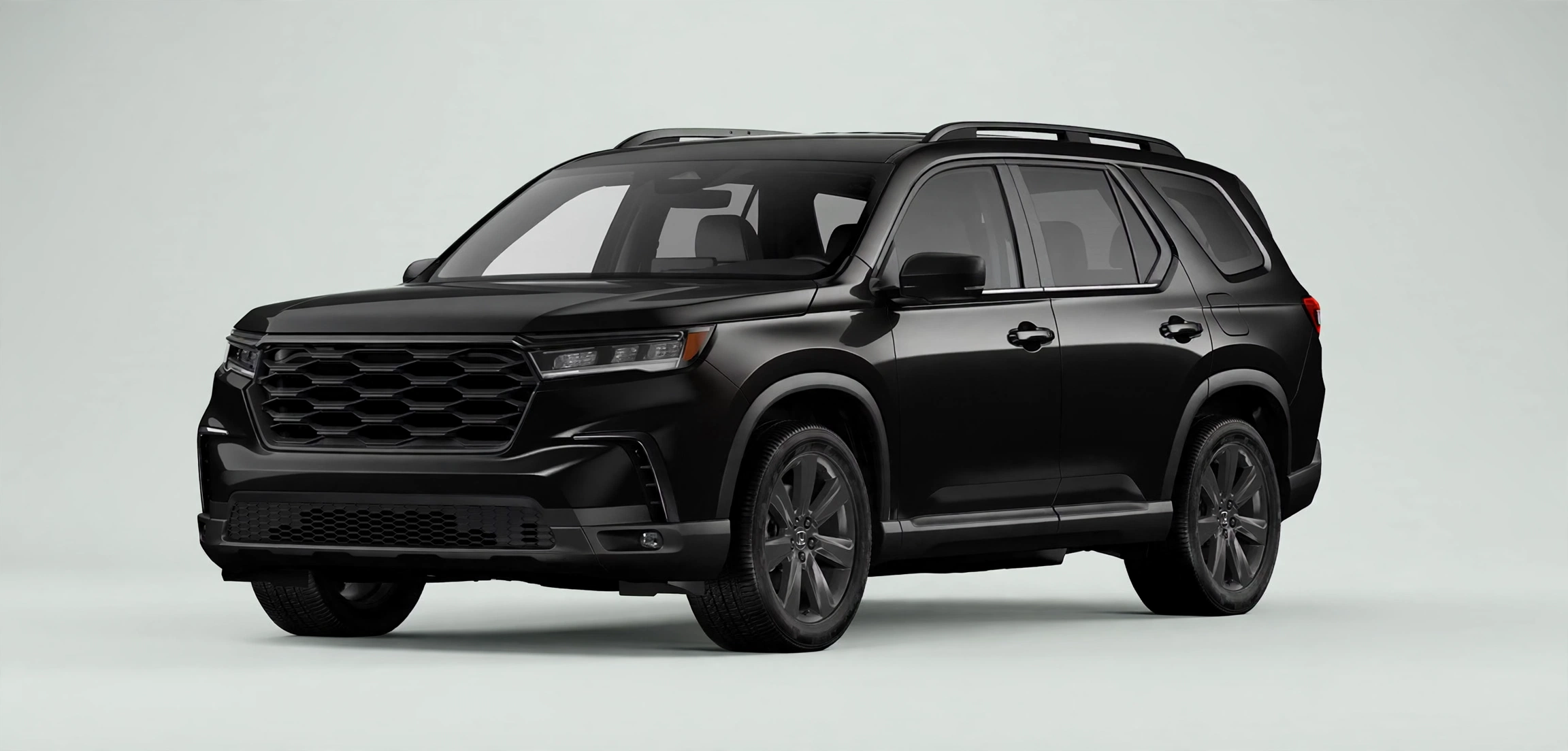 Black Honda Pilot three-row SUV in a studio, front three-quarter view
