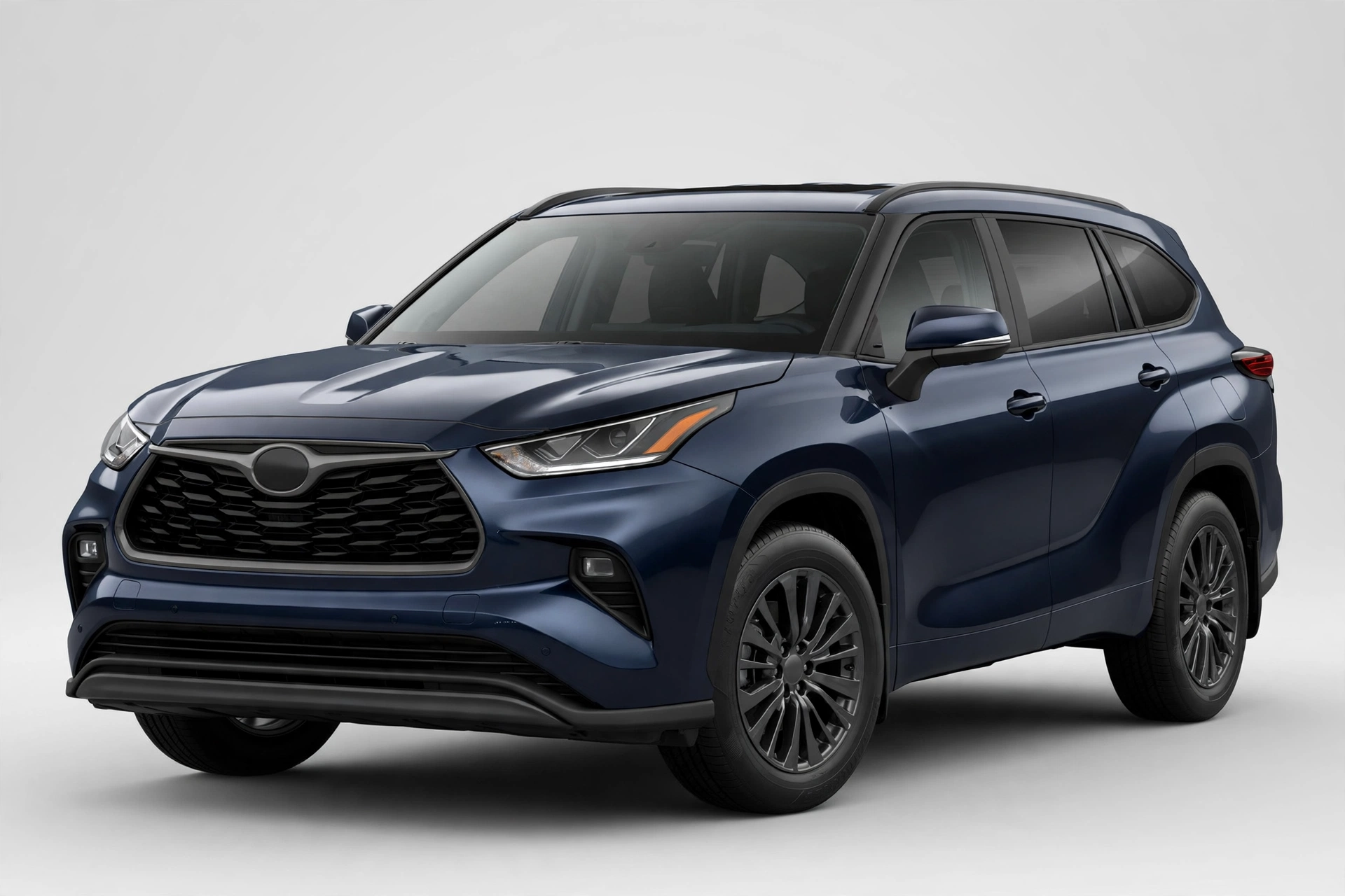Dark blue Toyota Highlander three-row SUV in a studio, front three-quarter view